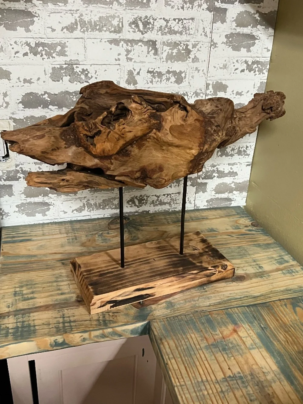 Natural weathered wood teak root rustic tabletop art piece supported by metal
